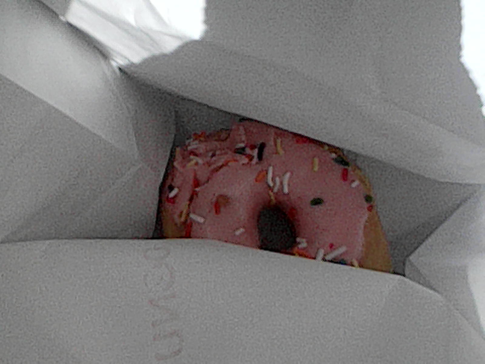 Pink donut in a bag.